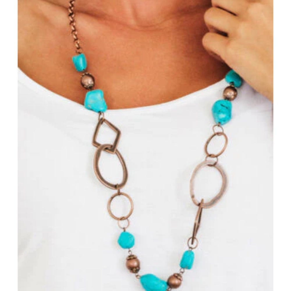 Turquoise stones and ornate copper beading asymmetrical necklace and earrings